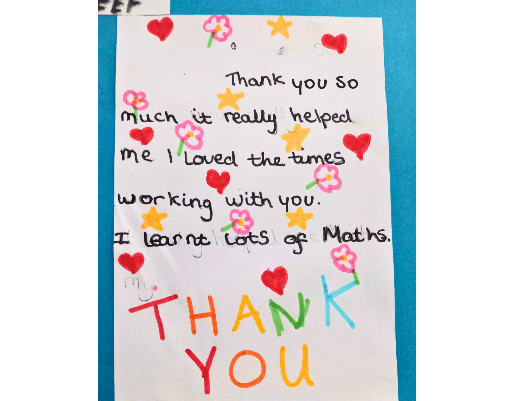 A multicoloured picture of a pupil's thank you note. The picture features a long note which shows the pupil's thanks to their tutor. The note is on a blue background with a white foreground with hearts, flowers and stars surrounding the wording, with a multicoloured 'THANK YOU' at the bottom.