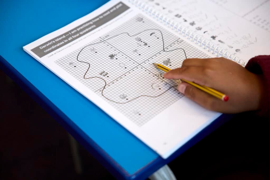 pupil working on workbook